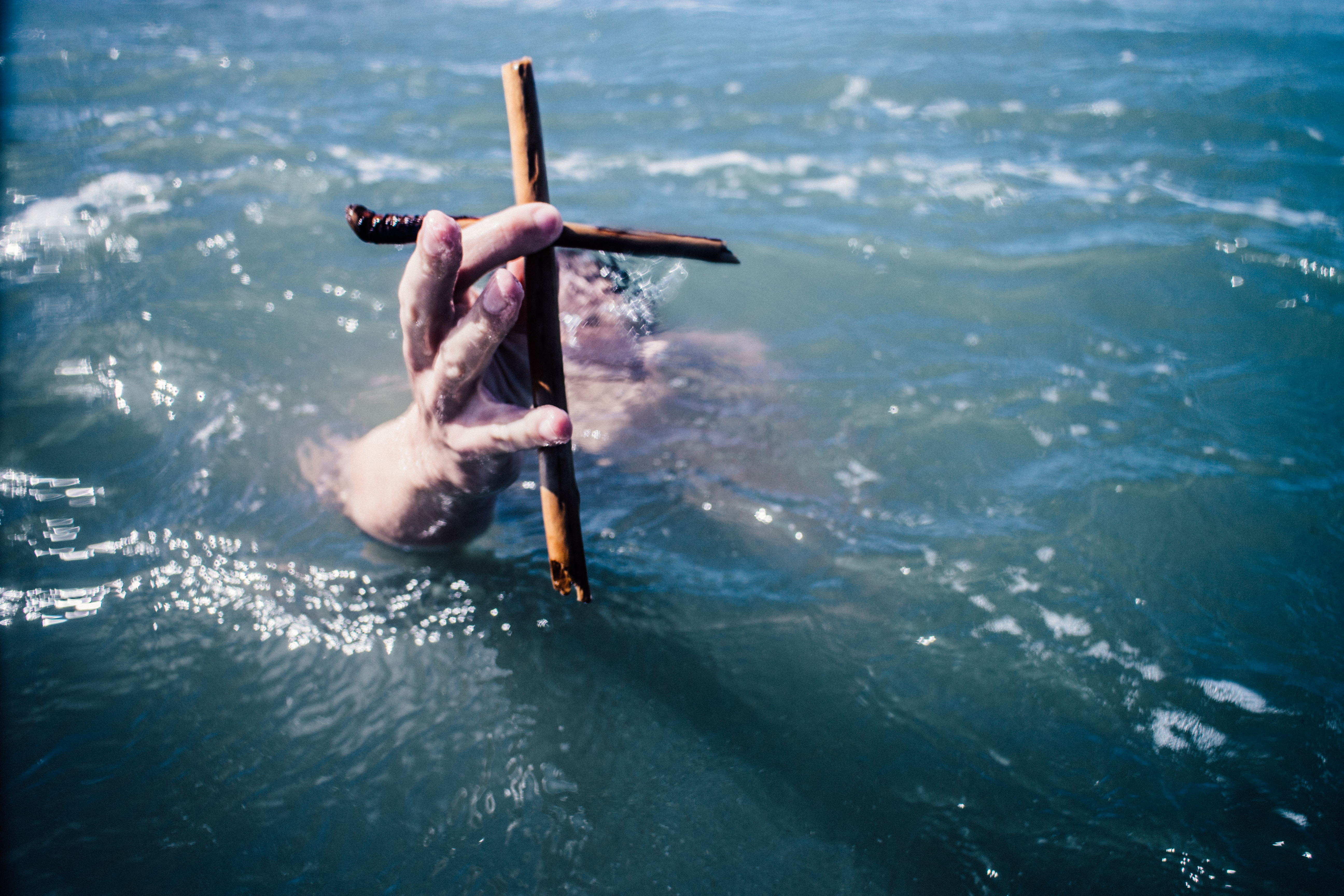 Man underwater but clinging to the cross of Grace